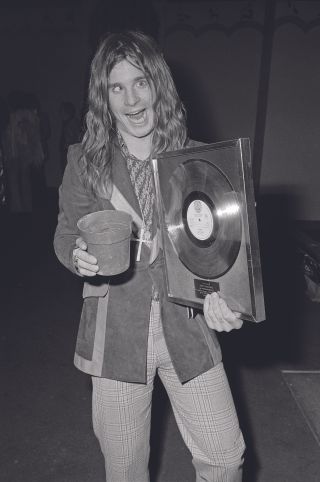 1973: Ozzy with a gold disc (and a flower pot...) for sales of 100,000 copies of Paranoid