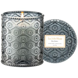 A dark blue patterned glass candle