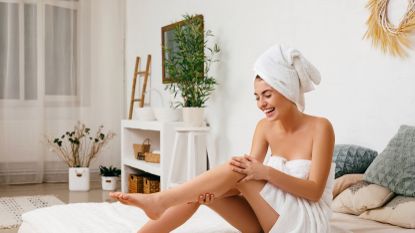 woman applying body moisturizer