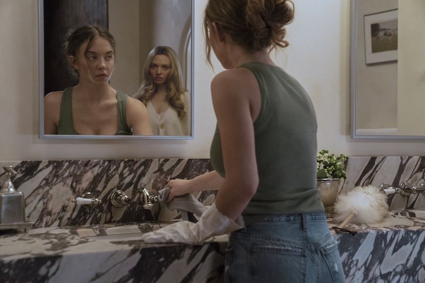 Sydney Sweeney standing at the mirror with Amanda Seyfried behind her in The Housemaid