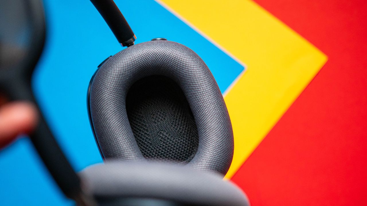 Apple AirPods Max 2 headset against a textured sheet showcasing the design