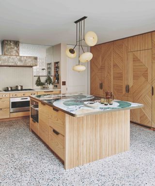 kitchen with wooden cabinetry and island with patterned marble countertop