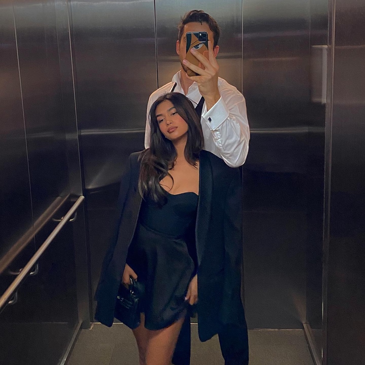 A couple taking a selfie in an elevator.