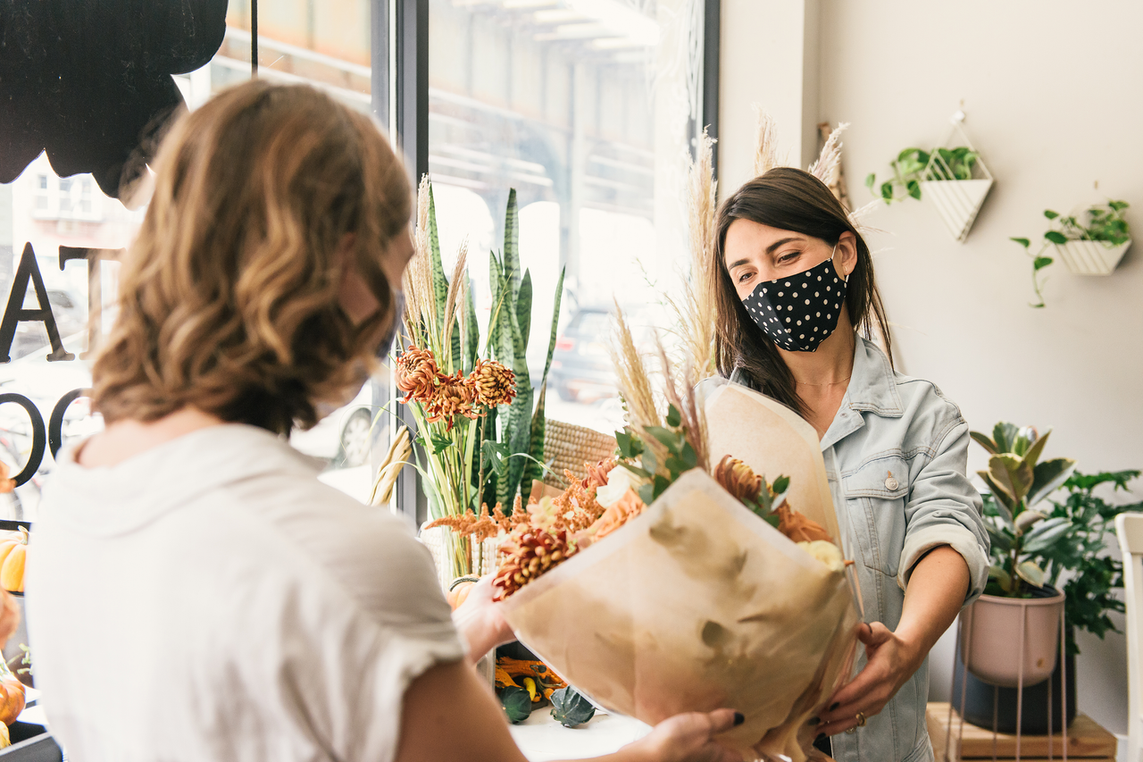 Woman selling flowers as date is announced for when shops can reopen in England