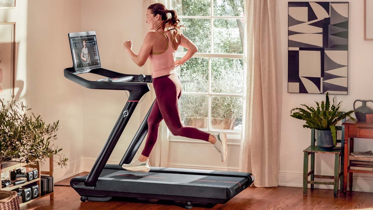 a photo of a woman running on the Peloton Tread