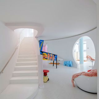 hallway with white walls and white staircase