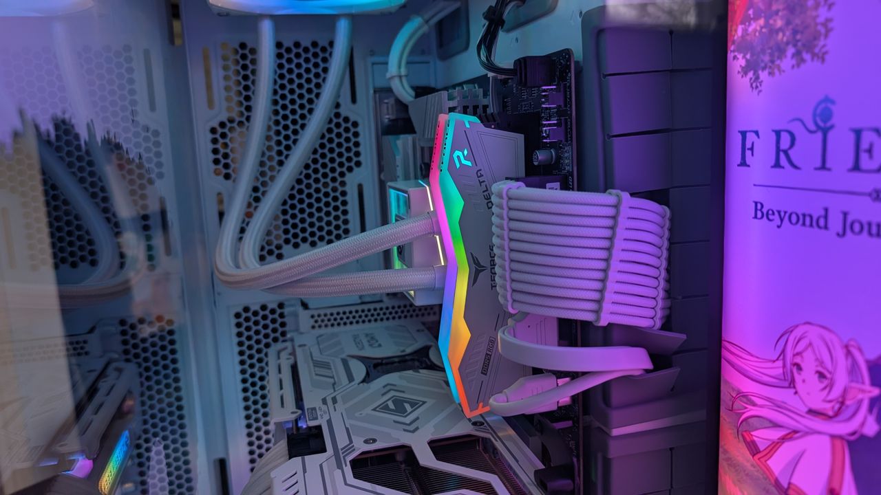 The Starforge Systems Frieren PC, photographed on a dark worktop with the RGB lighting switched on.