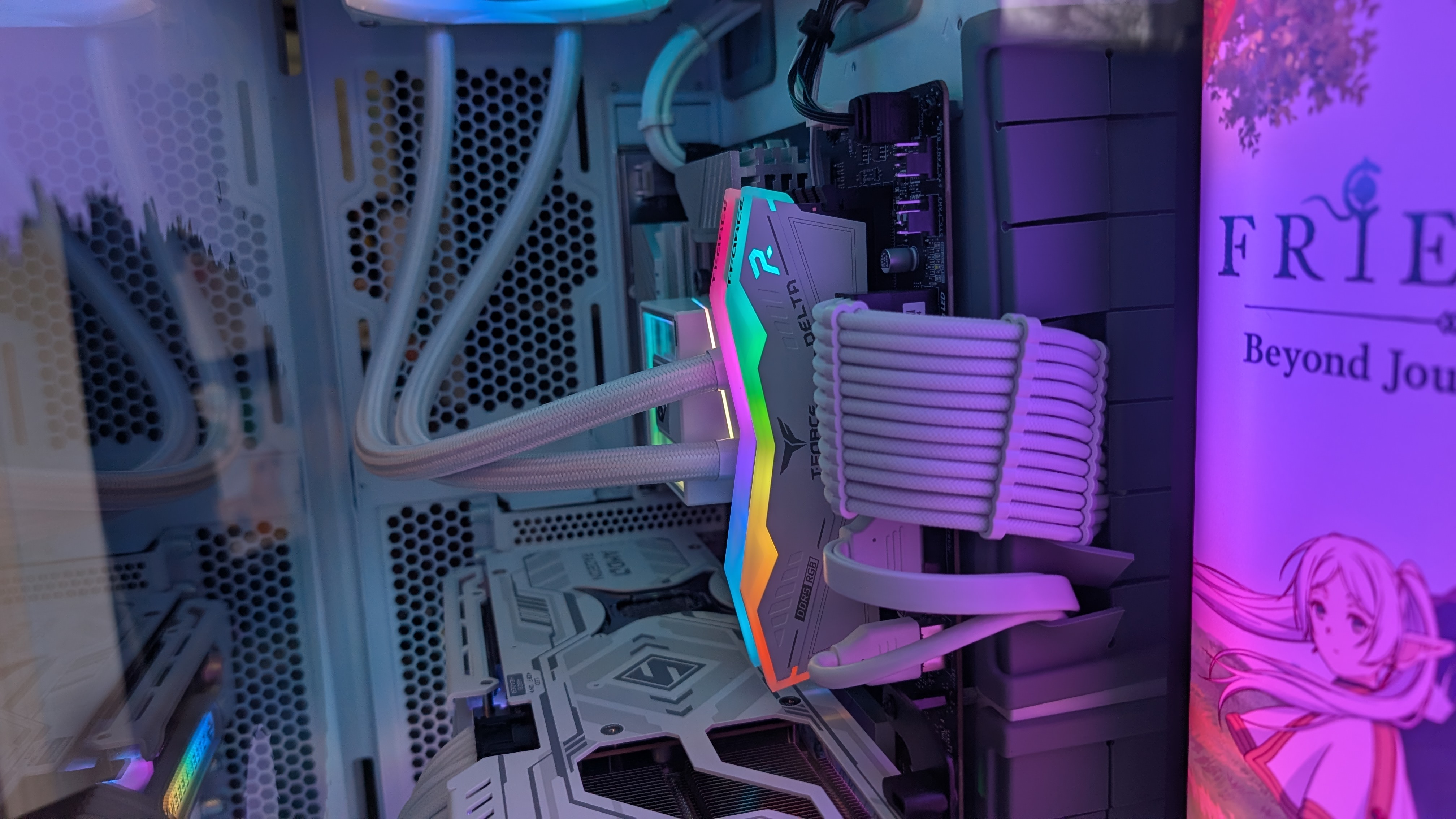 The Starforge Systems Frieren PC, photographed on a dark worktop with the RGB lighting switched on.