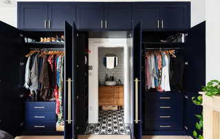Hidden ensuite behind a navy blue fitted wardrobe