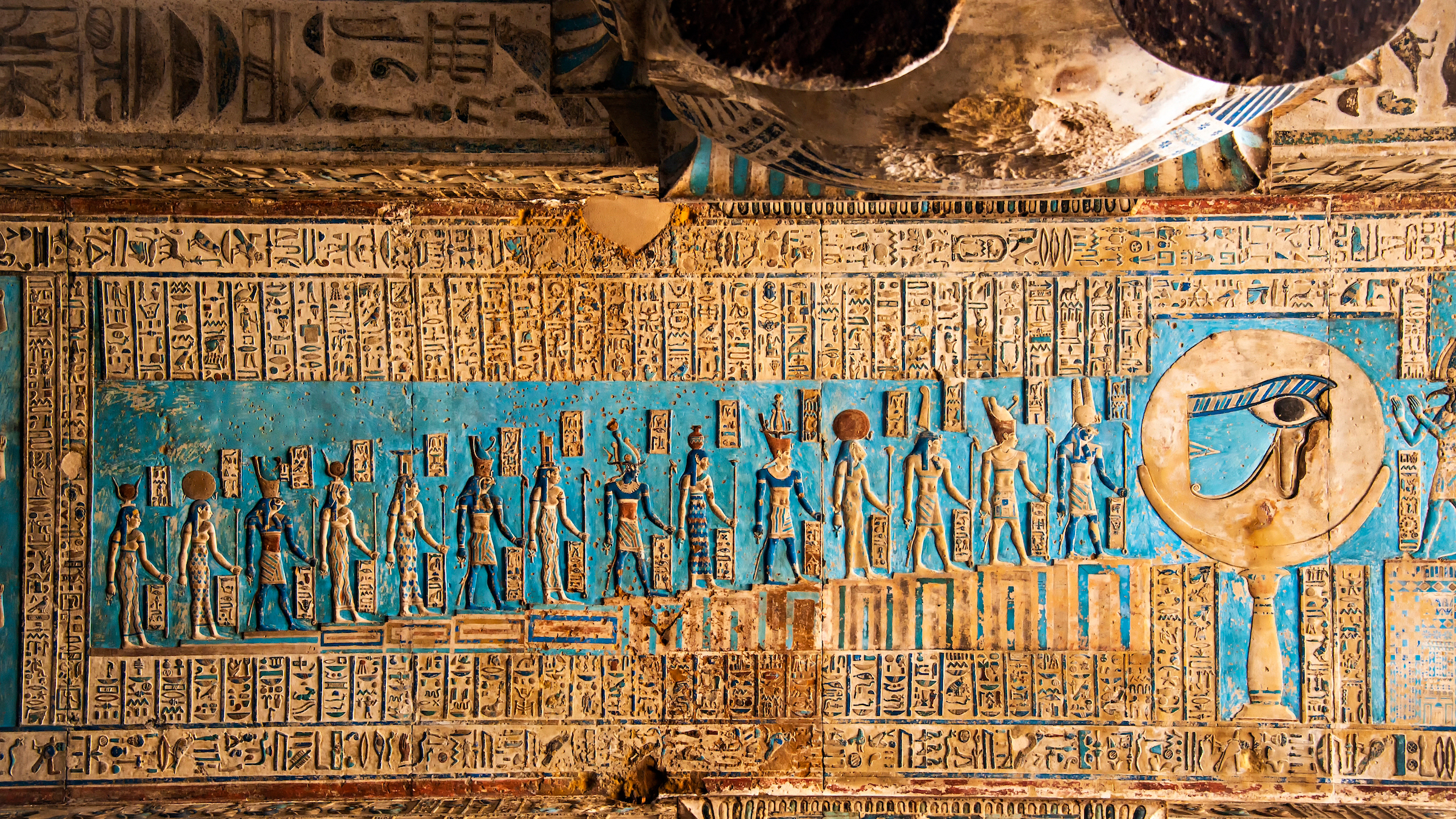 Ancient Egyptian hieroglyphs on the ceiling of Hypostyle Hall within the Temple of Hathor in Egypt.