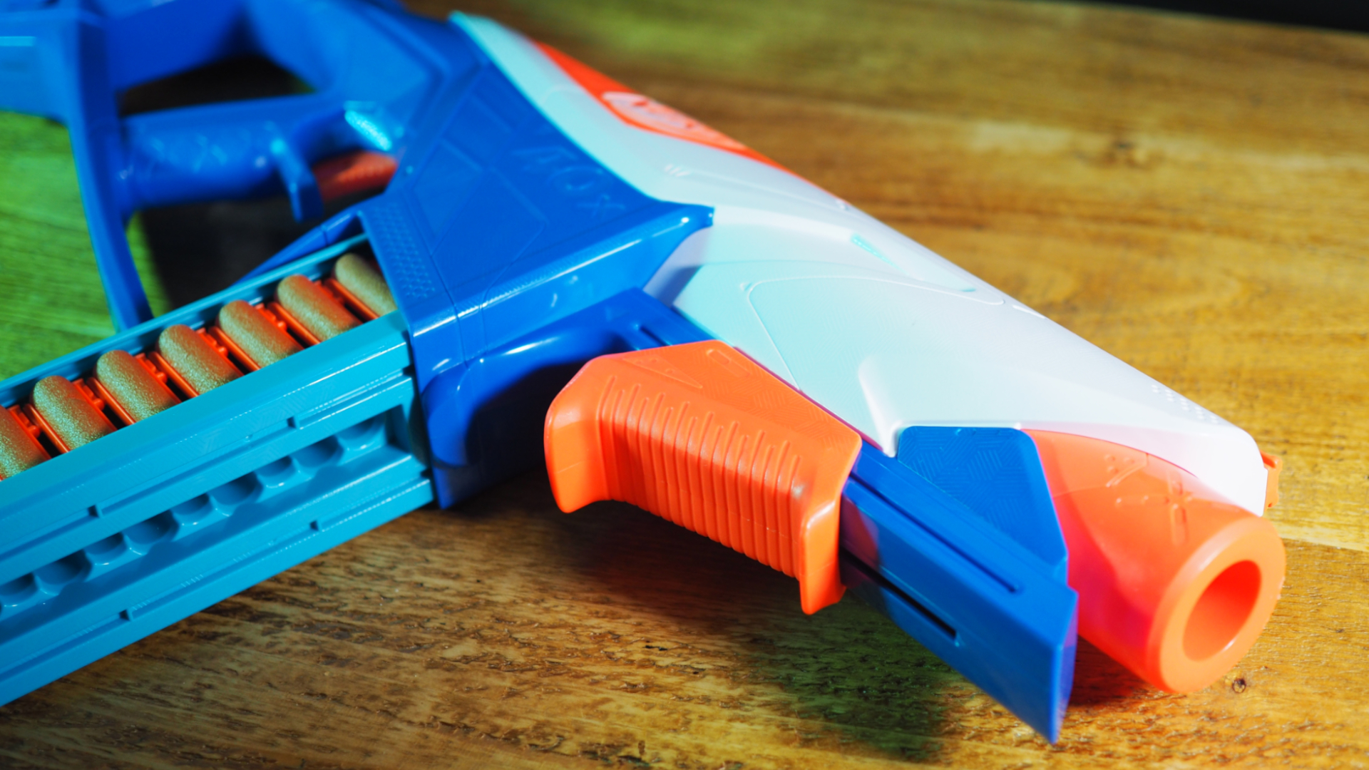 A Nerf N-Series Infinite blaster lying on a wooden table