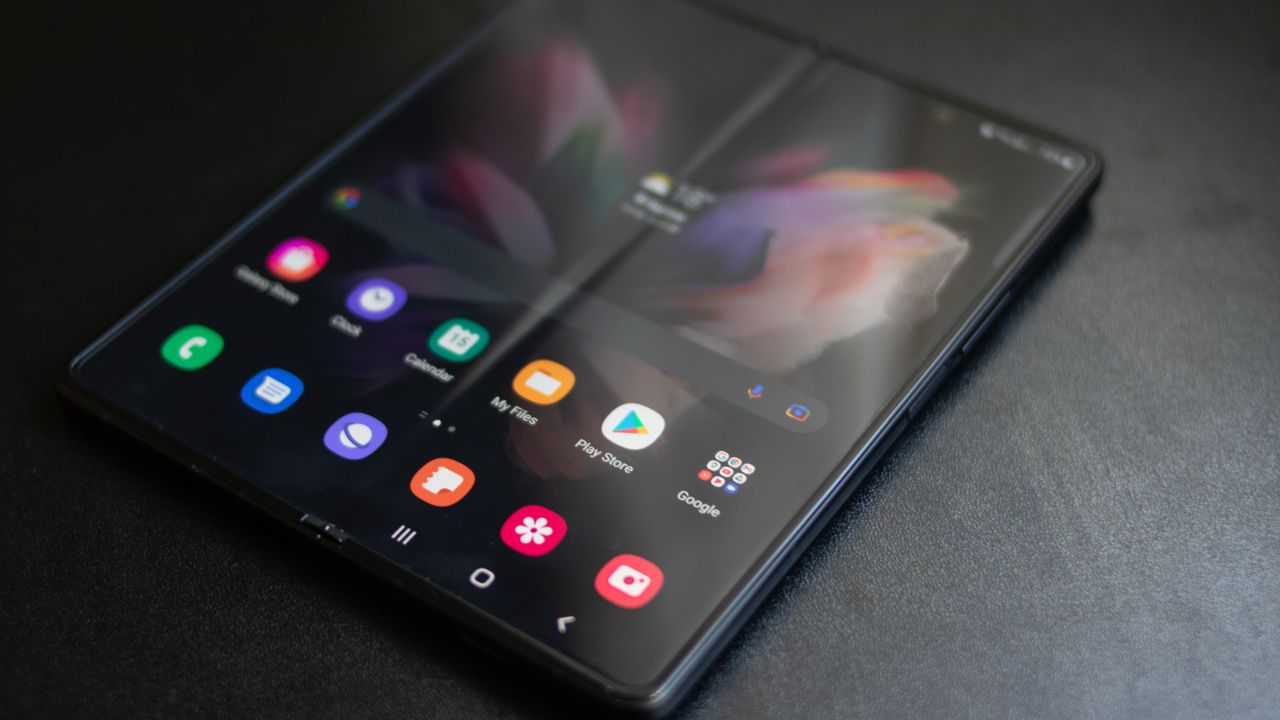 A photograph of the Samsung Galaxy Z Fold 3 unfolded and laid on a table