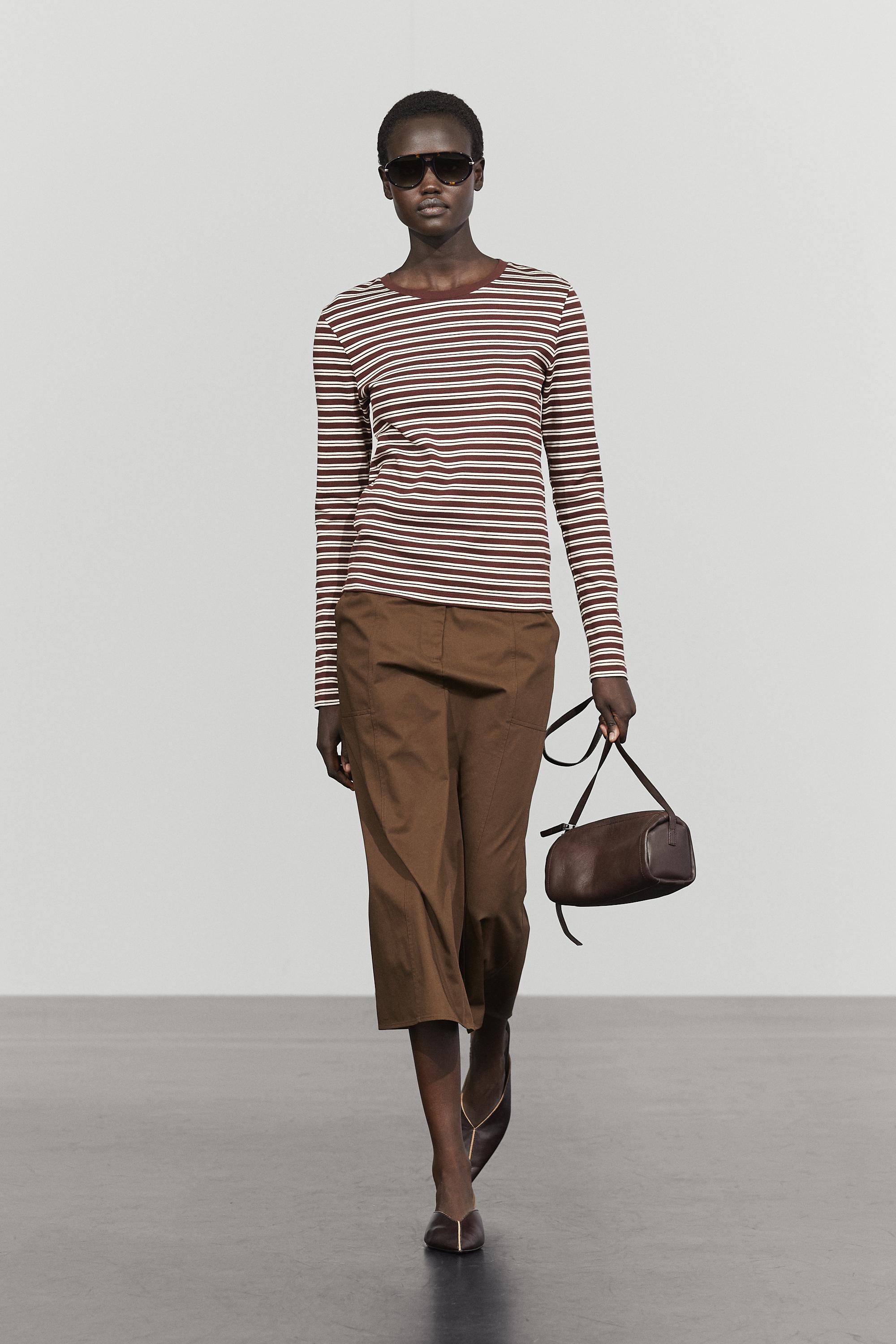 A model wearing a brown striped Massimo Dutti long sleeve t-shirt.