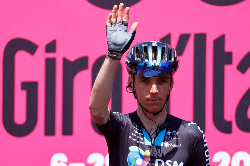 Team DSMs French rider Romain Bardet waves from the teams presentation podium prior to the start of the 6th stage of the Giro dItalia 2022 cycling race 192 kilometers between Palmi and Scalea Calabria on May 12 2022 Photo by Luca Bettini AFP Photo by LUCA BETTINIAFP via Getty Images