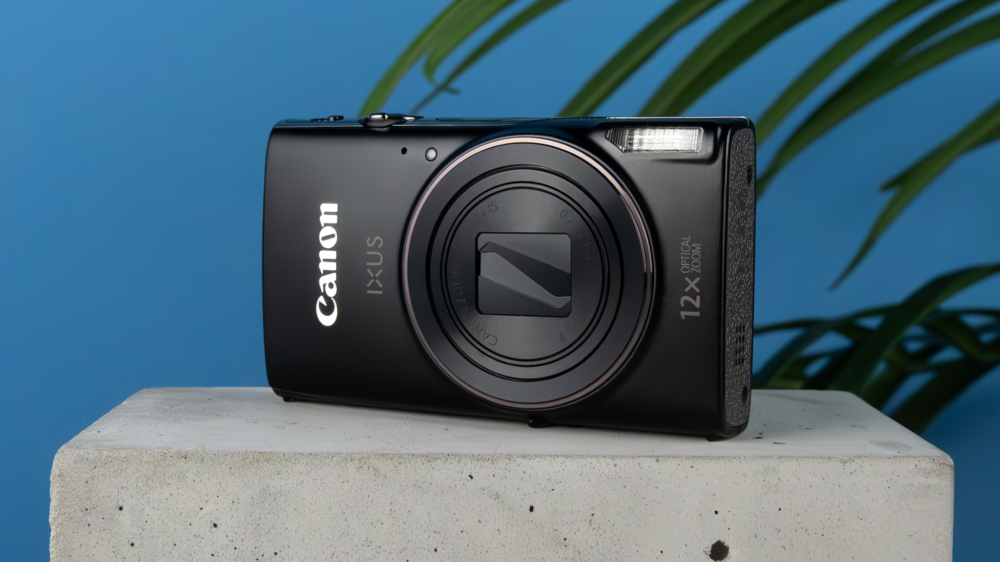 A black Canon PowerShot Elph 360 HS A or Canon PowerShot IXUS 285 HS A compact camera