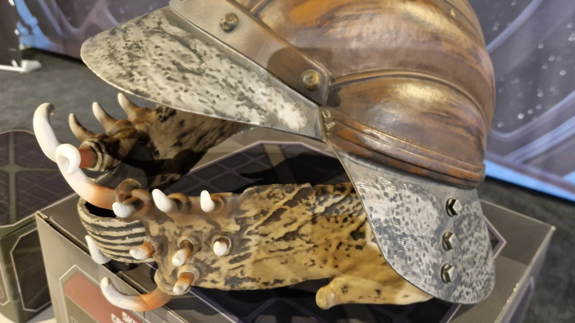 The Lando Calrissian Skiff Guard Helmet sat on a box, with the Star Wars logo visible in the background