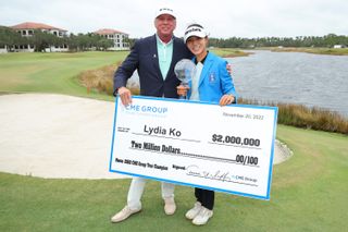Ko holds the cheque