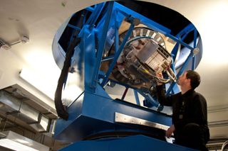 Graduate student Justus Brevik tests electronics inside of the BICEP2 telescope.