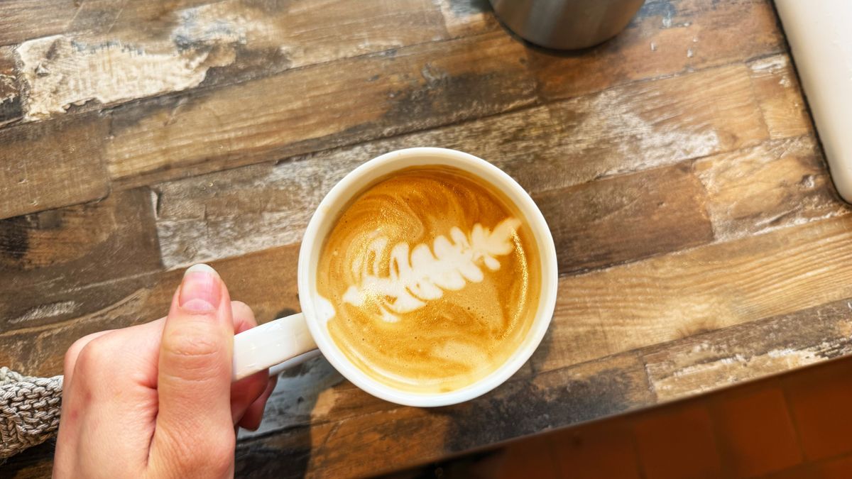 a latte made on the breville bambino plus the breville milk jug with narrow spout