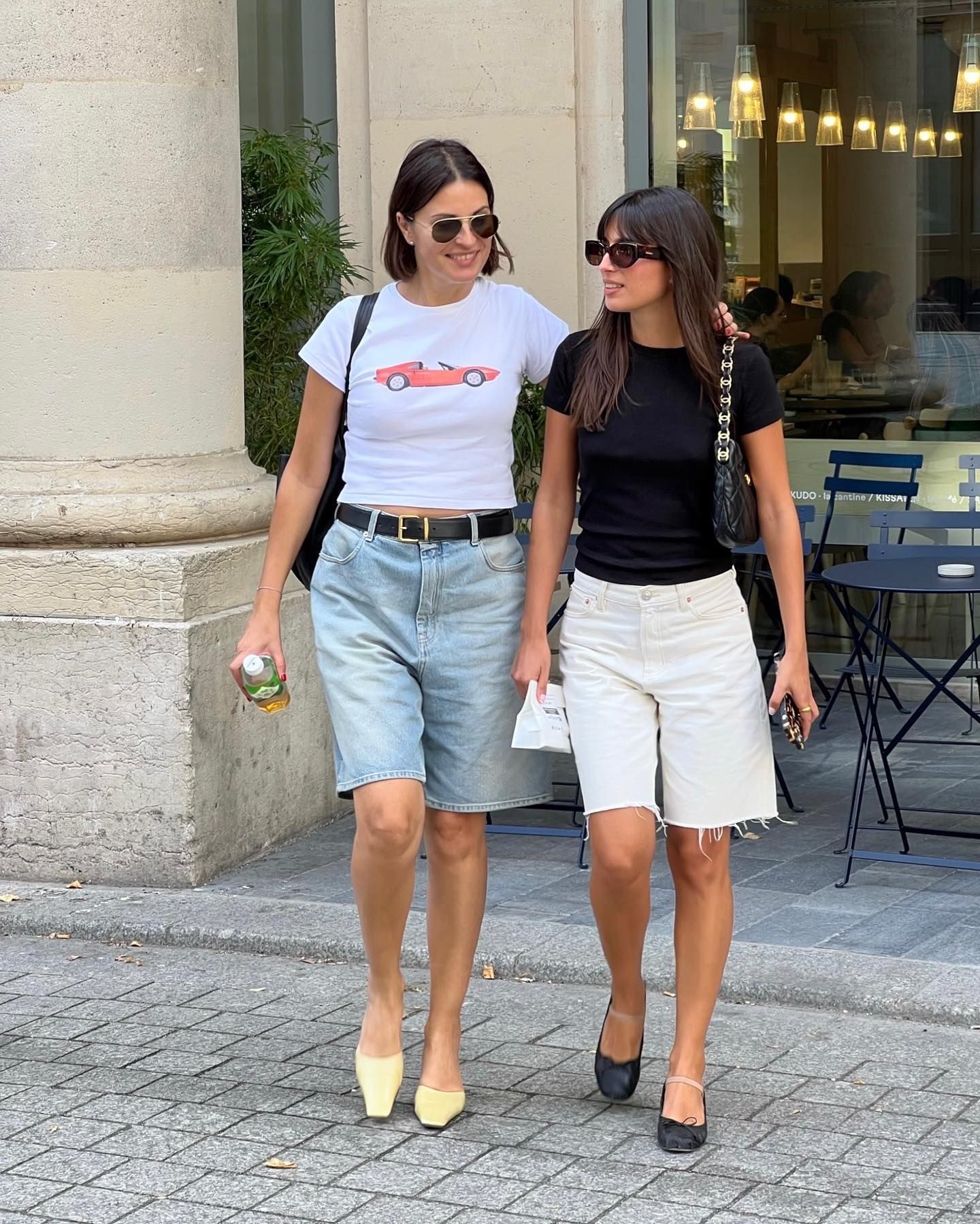 two women wear long denim shorts with short-sleeve T-shirts