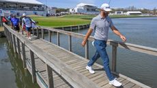 Dustin Johnson walks across the bridge towards the 14th tee box at the 2022 WGC-Match Play