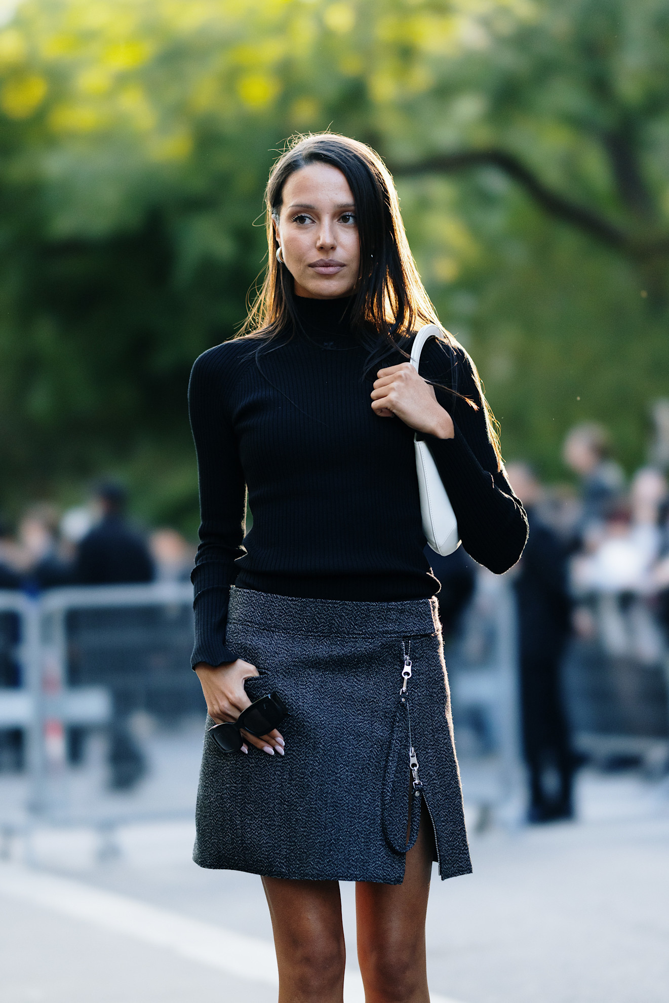 woman wearing black turtleneck and wool skirt