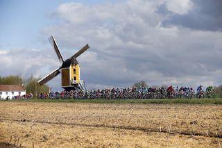 The pack compete in front of the Hubertus mill on April 17, 2016 during the Amstel Gold Race in Beek.