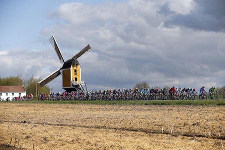 The pack compete in front of the Hubertus mill on April 17, 2016 during the Amstel Gold Race in Beek.