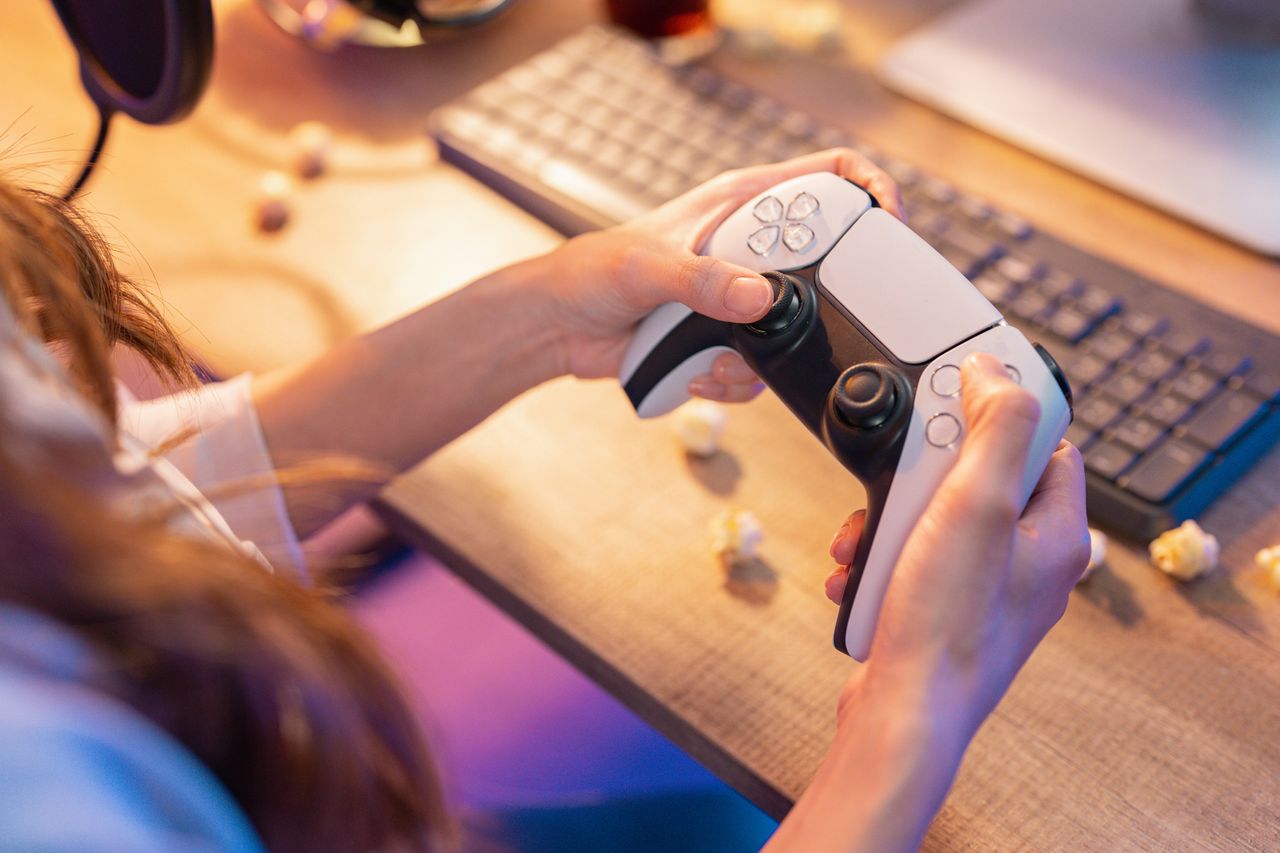 Woman Playing Video Game At Home