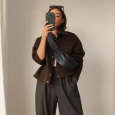 Influencer wears barrel leg trousers.