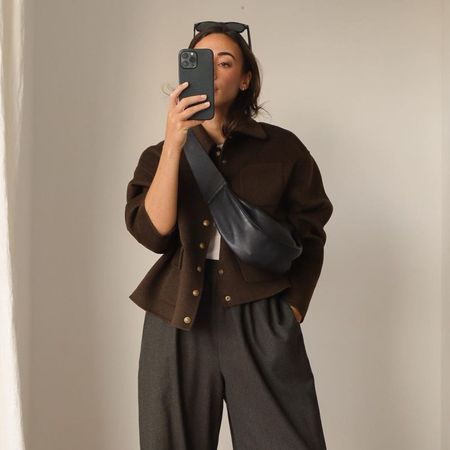 Influencer wears barrel leg trousers.