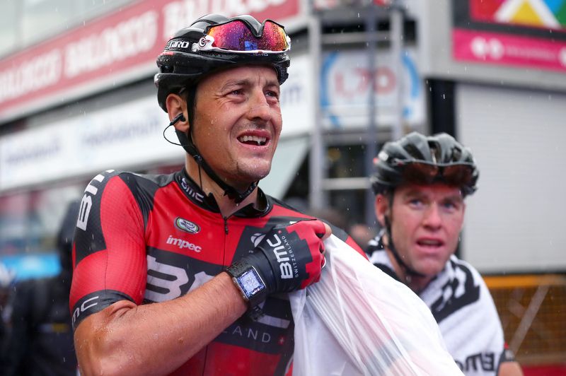 Marcus Burghartd may be cold and wet but undoubtedly warmed by the fact that teammate Philippe Gilbert took the stage win