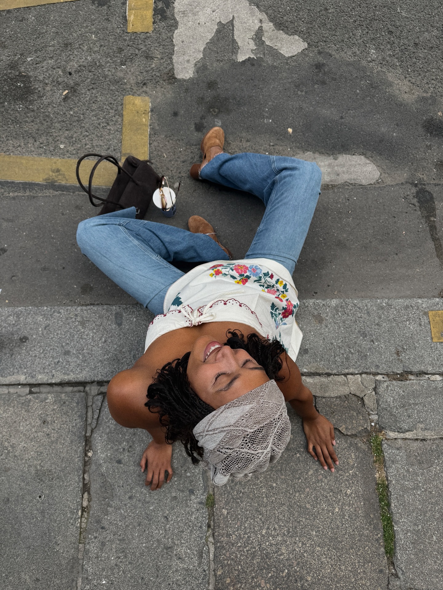 Lena Farl wears a strapless embroidered top, jeans and suede shoes