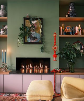 Green living room with open shelving and pale pink cabinetry