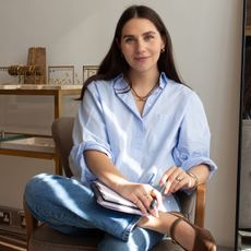 jewellery designer laura vann poses in her office