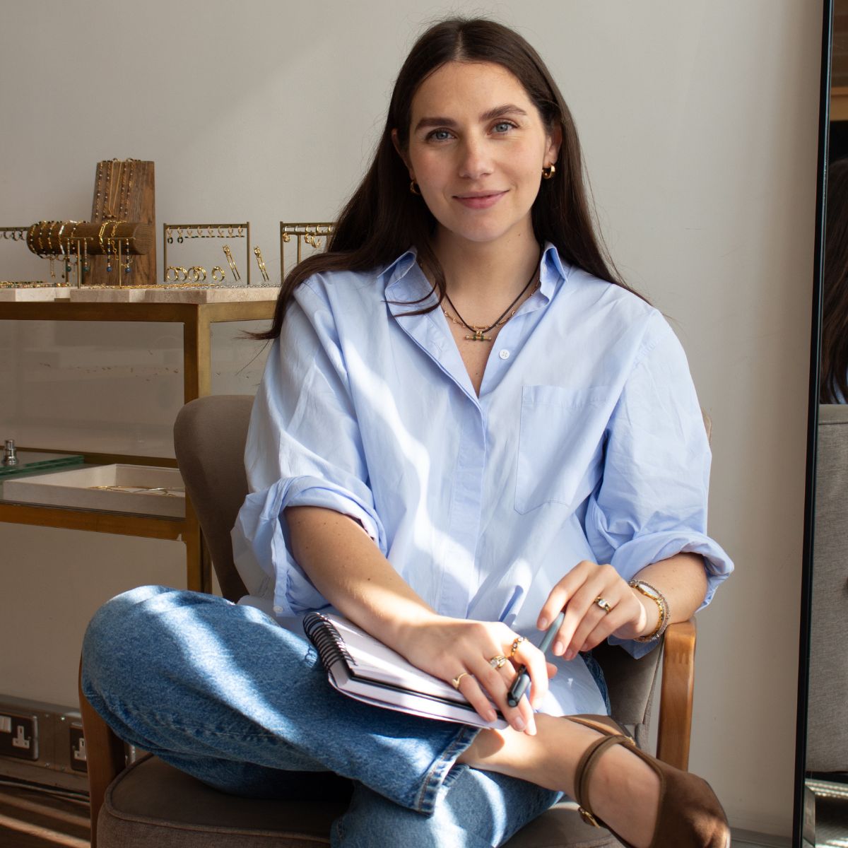 jewellery designer laura vann poses in her office