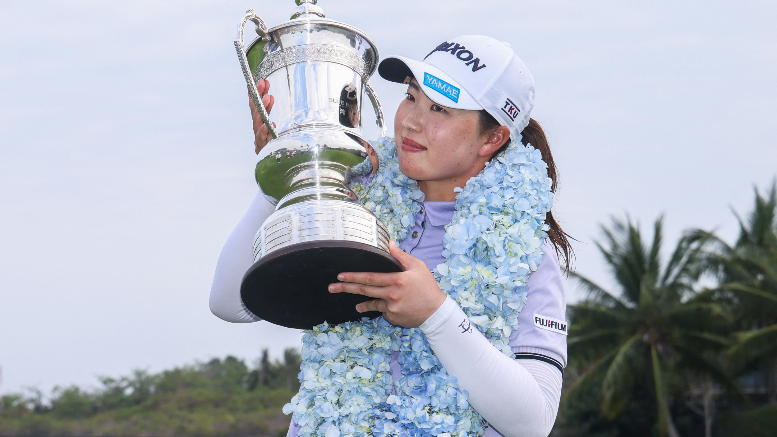 Rio Takeda with the Blue Bay LPGA trophy