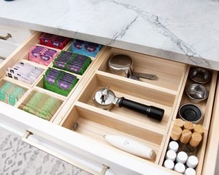 Coffee drawer with wooden drawer divider and tea and coffee essentials