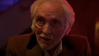 Terence Stamp sits at the bar talking in Last Night In Soho.