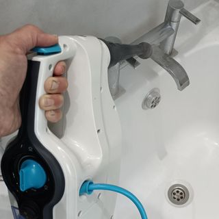 Vax Steam Fresh Combi S86-SF-C Steam Mop hand held unit being filled in a bathroom sink