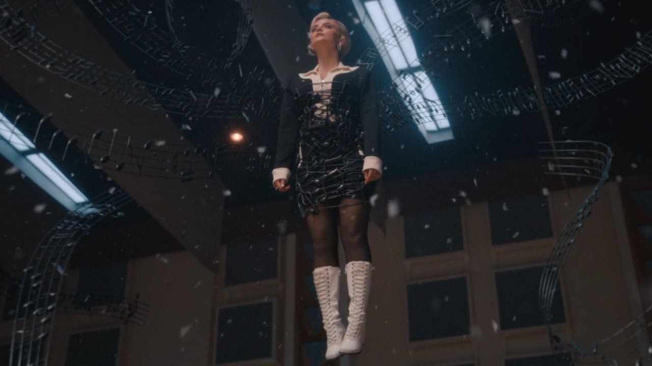 Ruby Sunday enveloped in music hanging in the air in Doctor Who with snow falling around her.