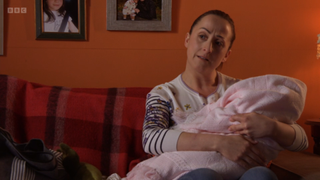 Sonia Fowler cradling baby Charli in a pink blanket.