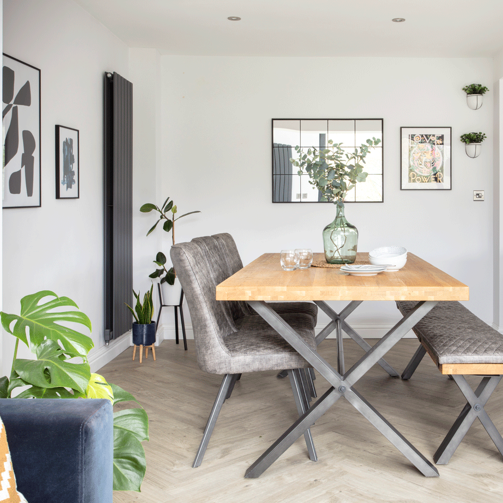dining area with vase with wooden flooring
