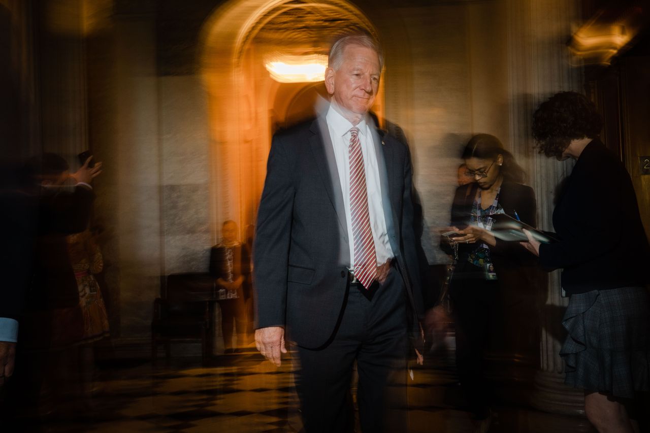 Sen. Tommy Tuberville walking through a darkened hall in Washington, D.C.