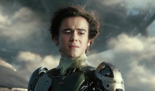 Alita: Battle Angel Hugo stands teary eyed on a tether to Zalem