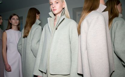 Female models dressed in the Jil Sander A/W 2014 backstage of the fashion show