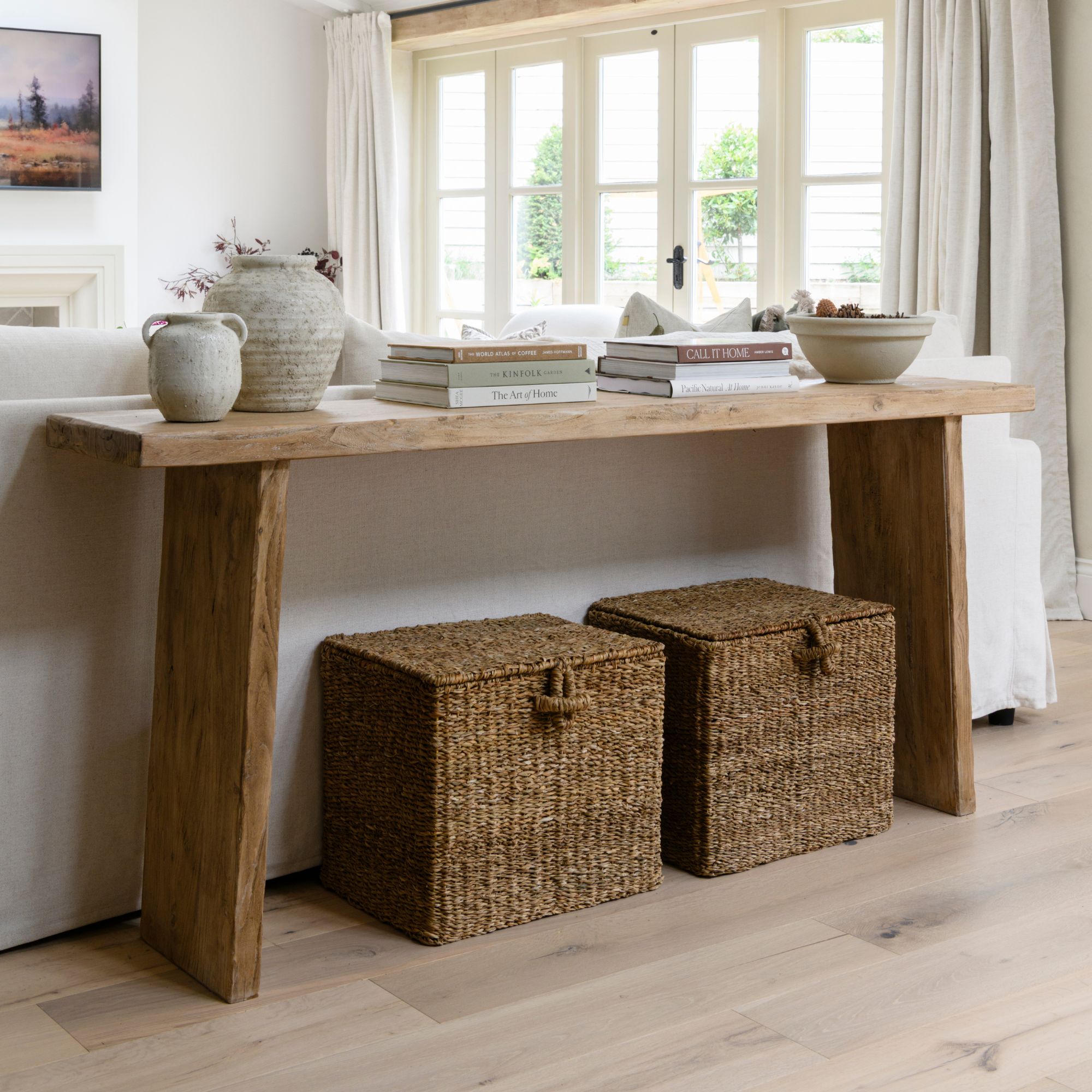 Living room storage area with a console table and two storage boxes underneath it
