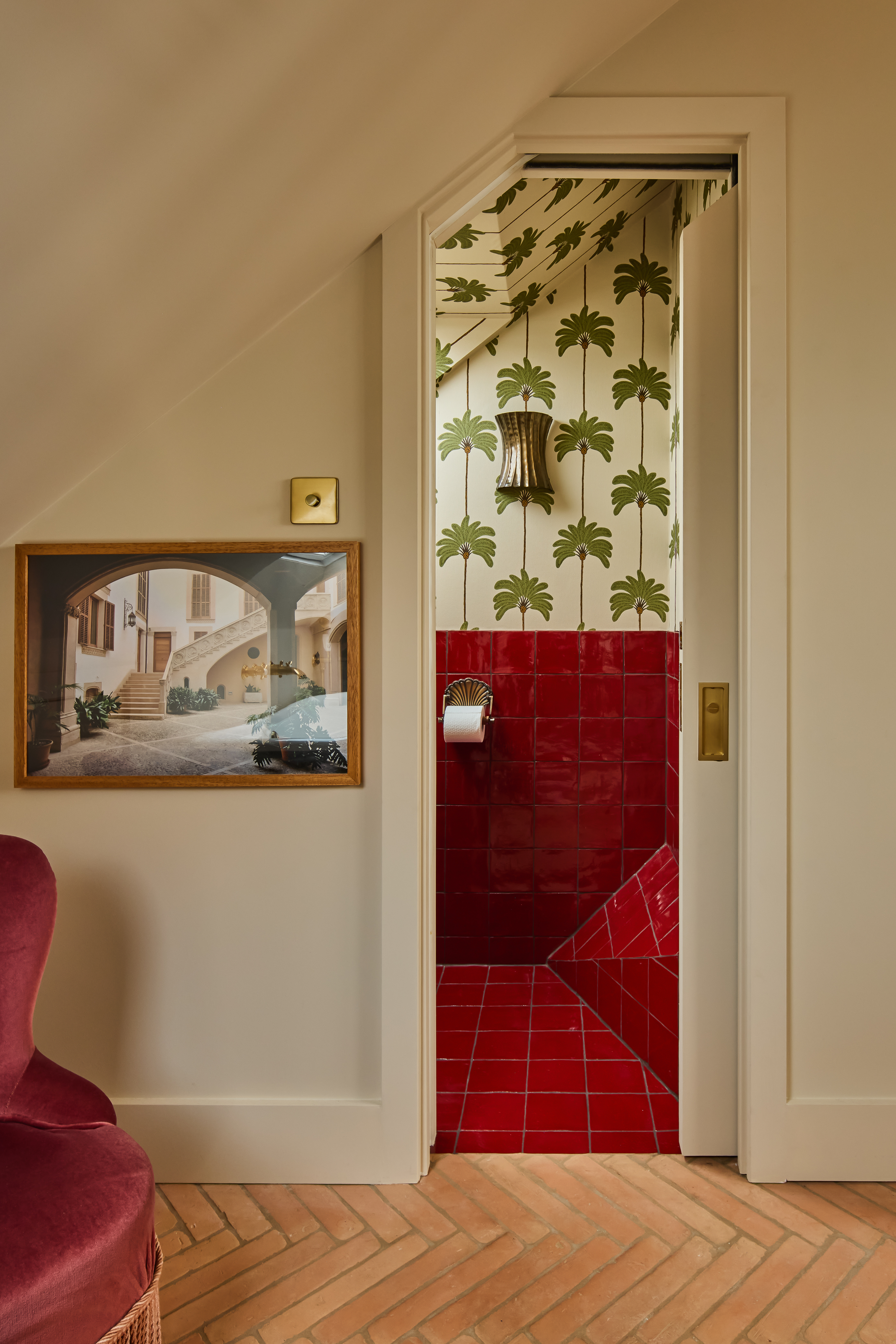 red tiled ensuite bathroom viewed through a door in a loft conversion