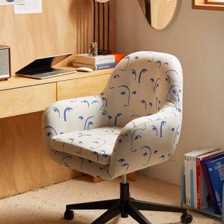 White chair with blue illustrated design in home office space