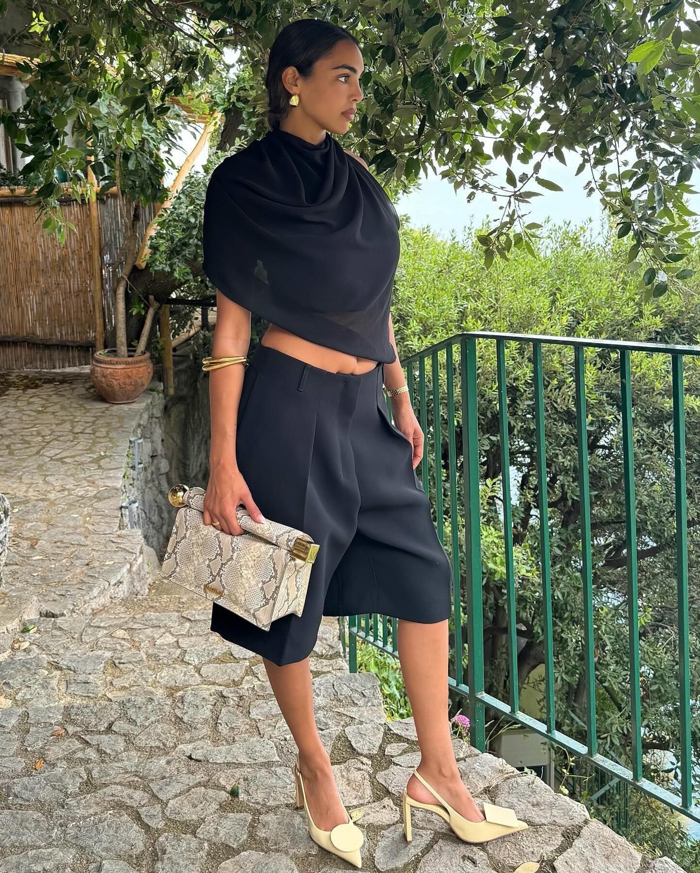 Influencer wears yellow heels.